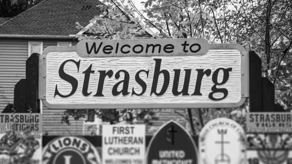 Welcome to Strasburg sign surrounded by local organization signs
